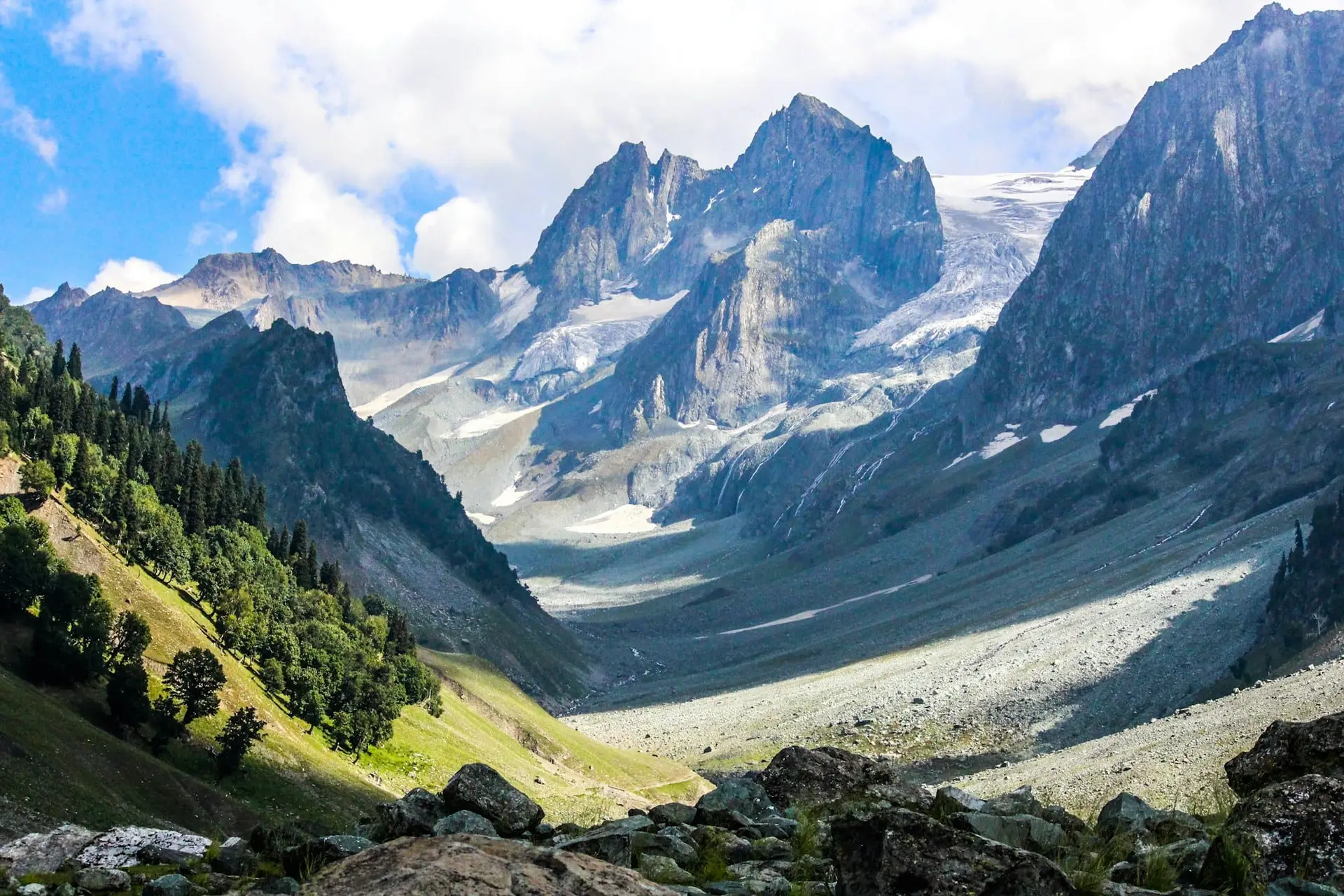 Snow-streaked peaks rising over the green slopes of Sonamarg