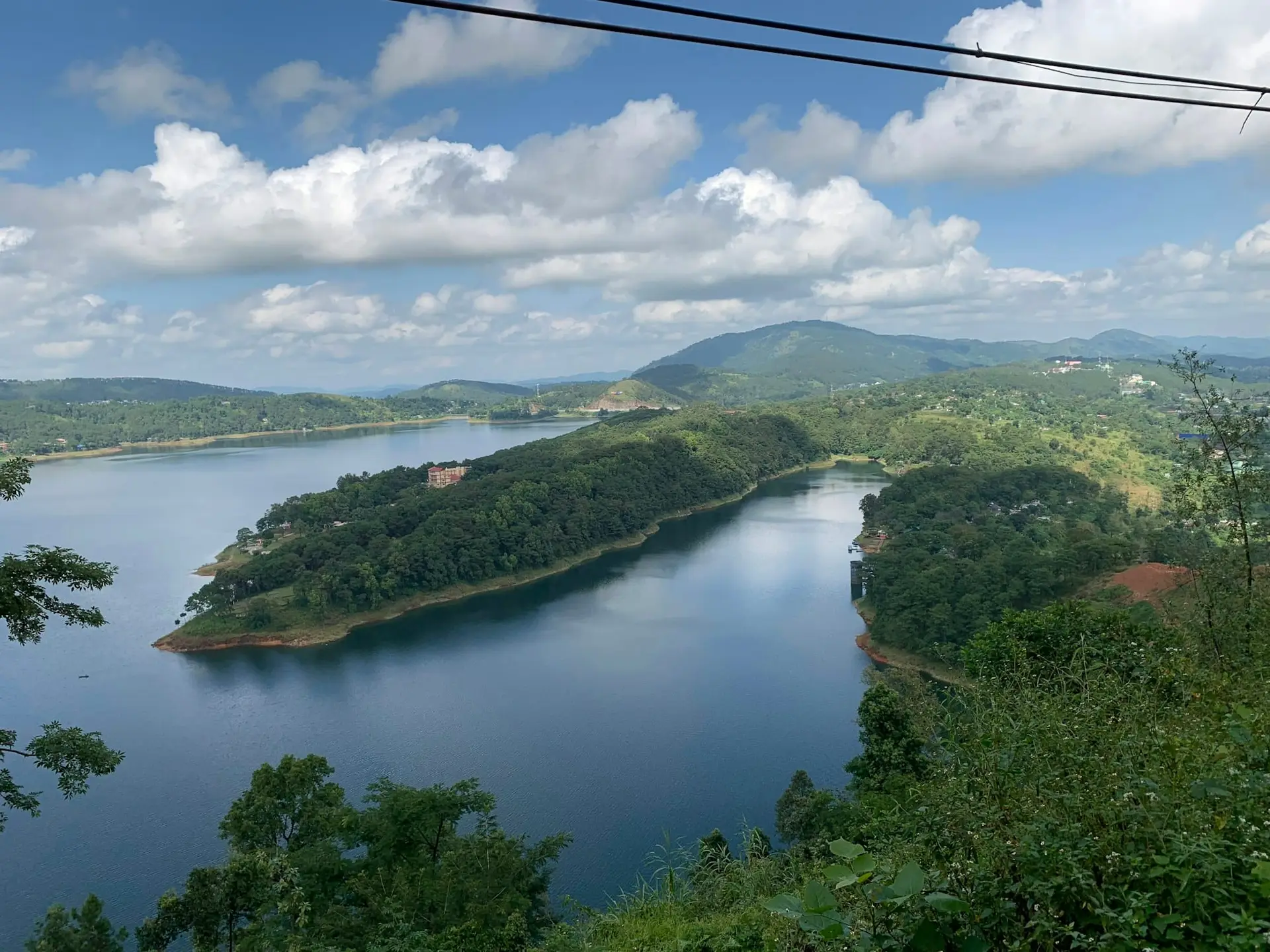 Wooded islands in the blue water of Umiam Lake outside Shillong