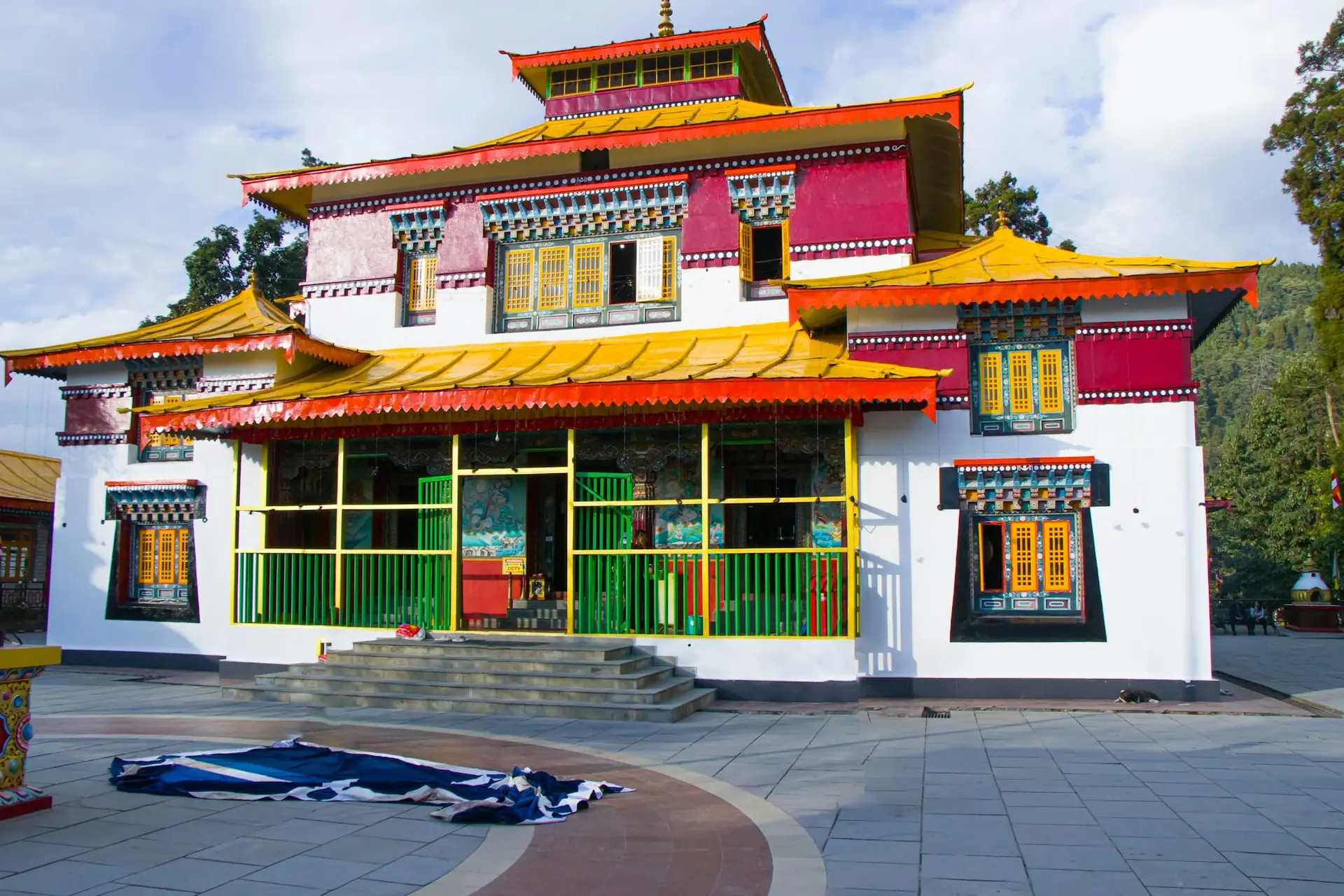 A white monastery with a golden roof in Pelling