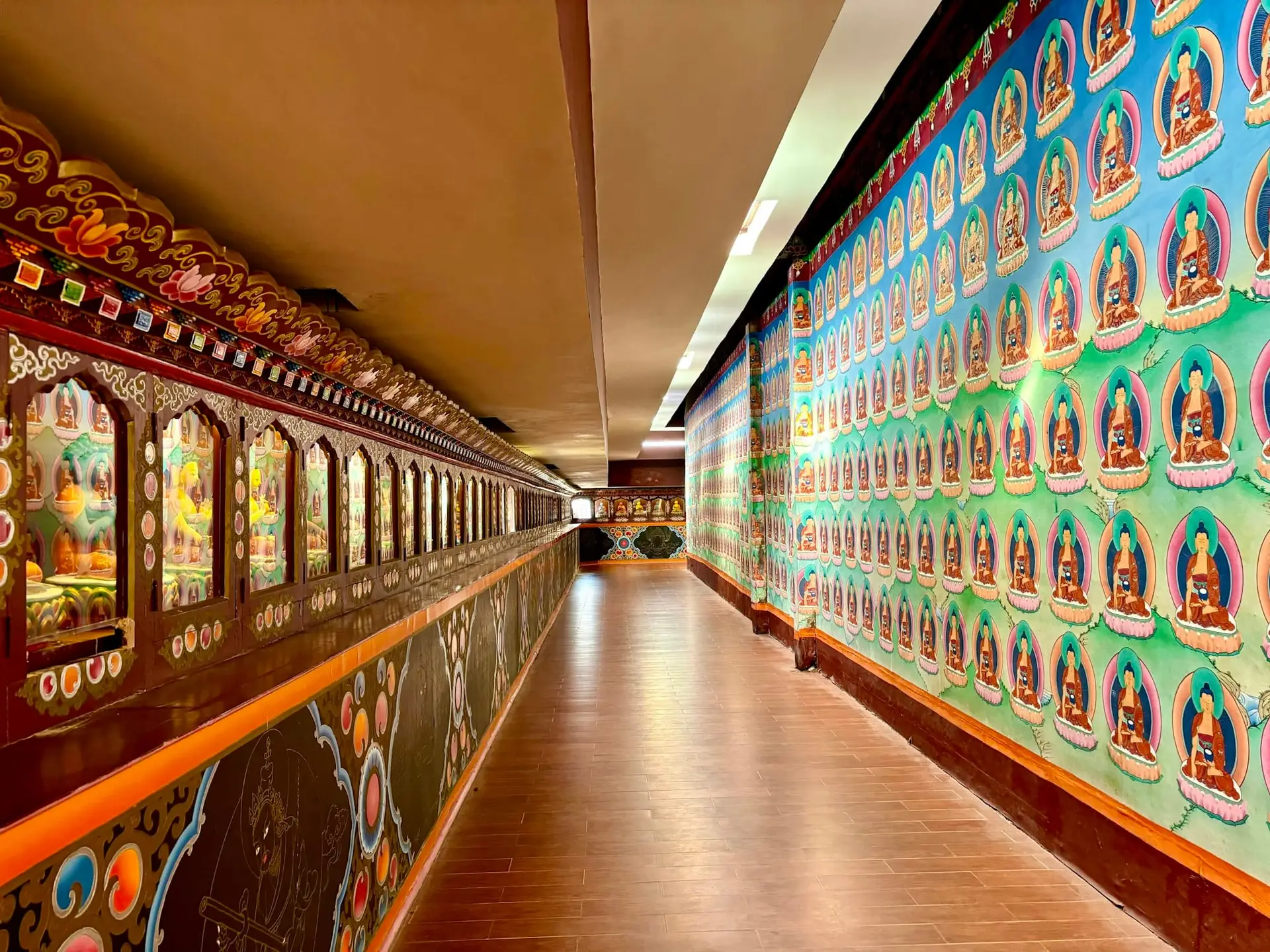 A long corridor of painted prayer wheels in Ravangla